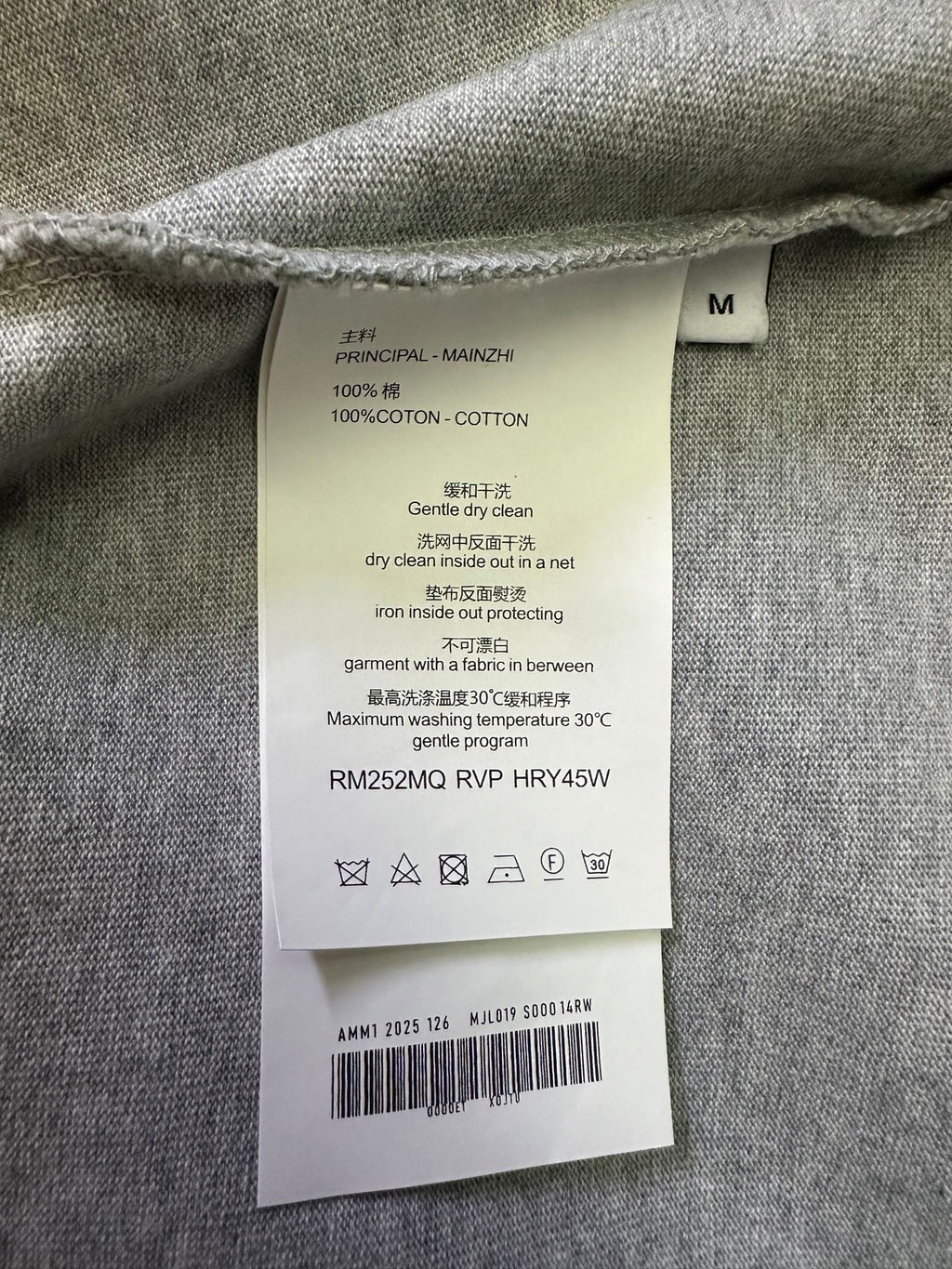 T-shirt care label tag with fabric content and washing instructions