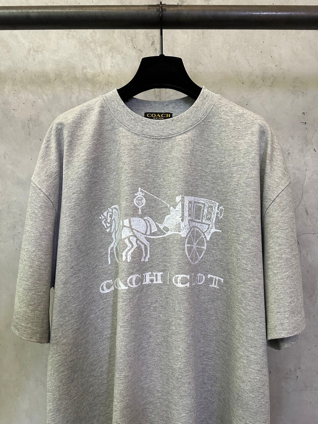 Heather gray T-shirt front with white Coach logo and carriage graphic