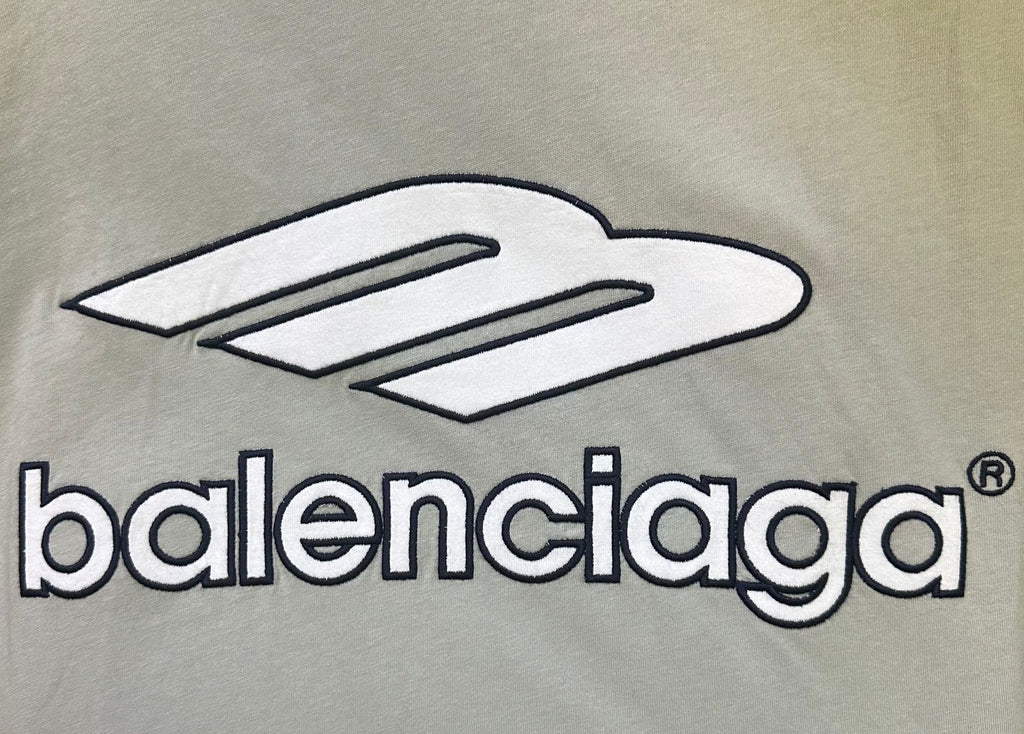 Close-up of balenciaga logo print on light sage T-shirt