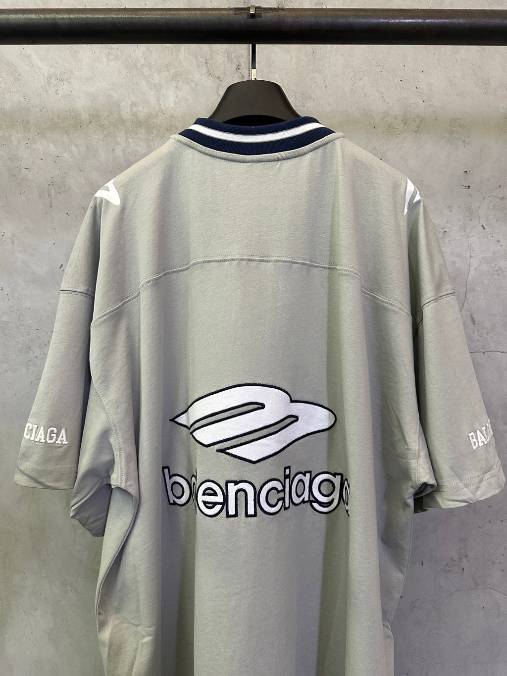 Light sage short-sleeve T-shirt back view with large balenciaga logo graphic
