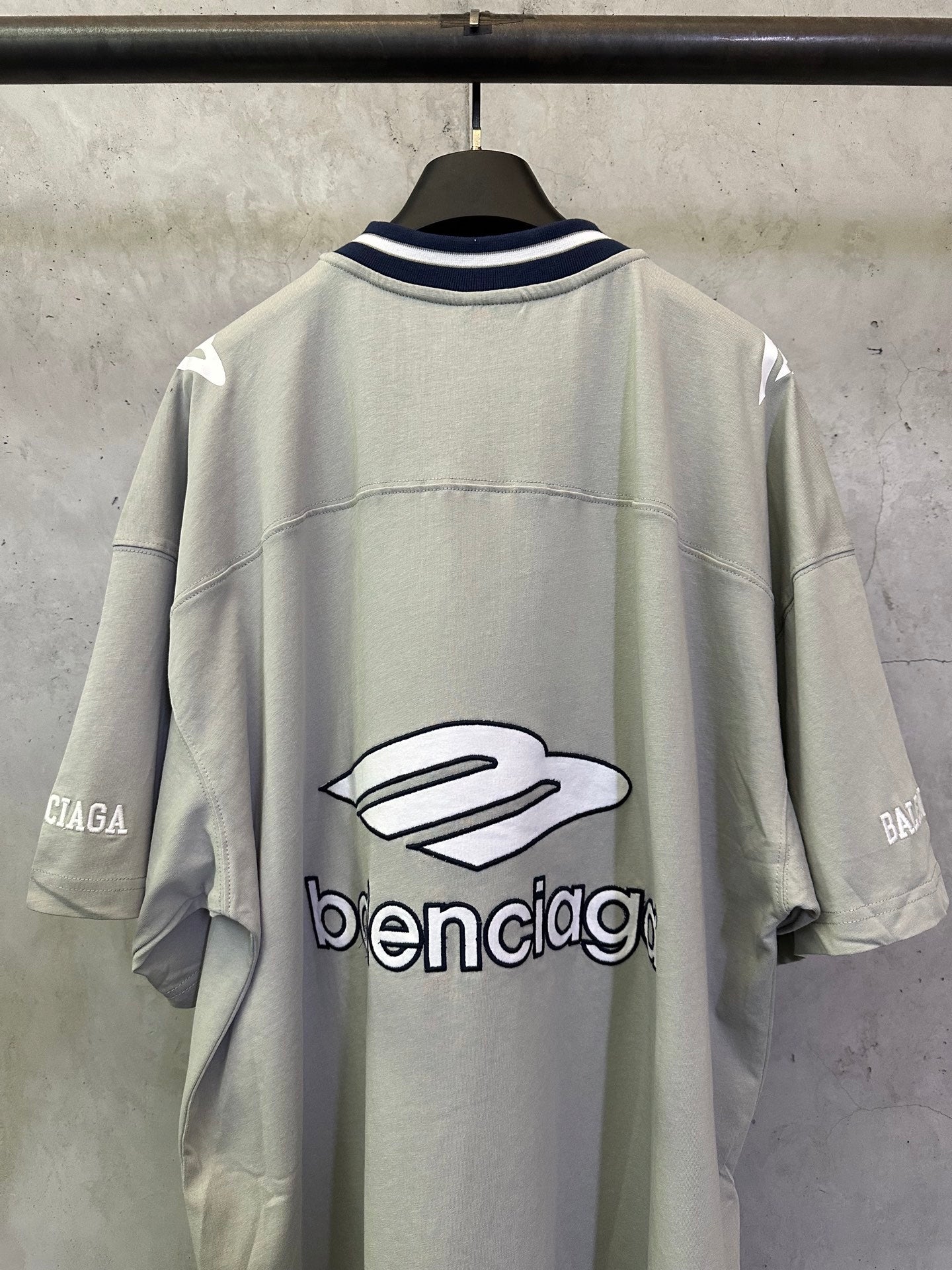 Light sage short-sleeve T-shirt back view with large balenciaga logo graphic