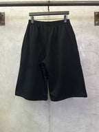 Black athletic shorts with relaxed fit and drawstring front