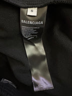 Black shorts interior with Balenciaga size tag and care label stitched on seam.