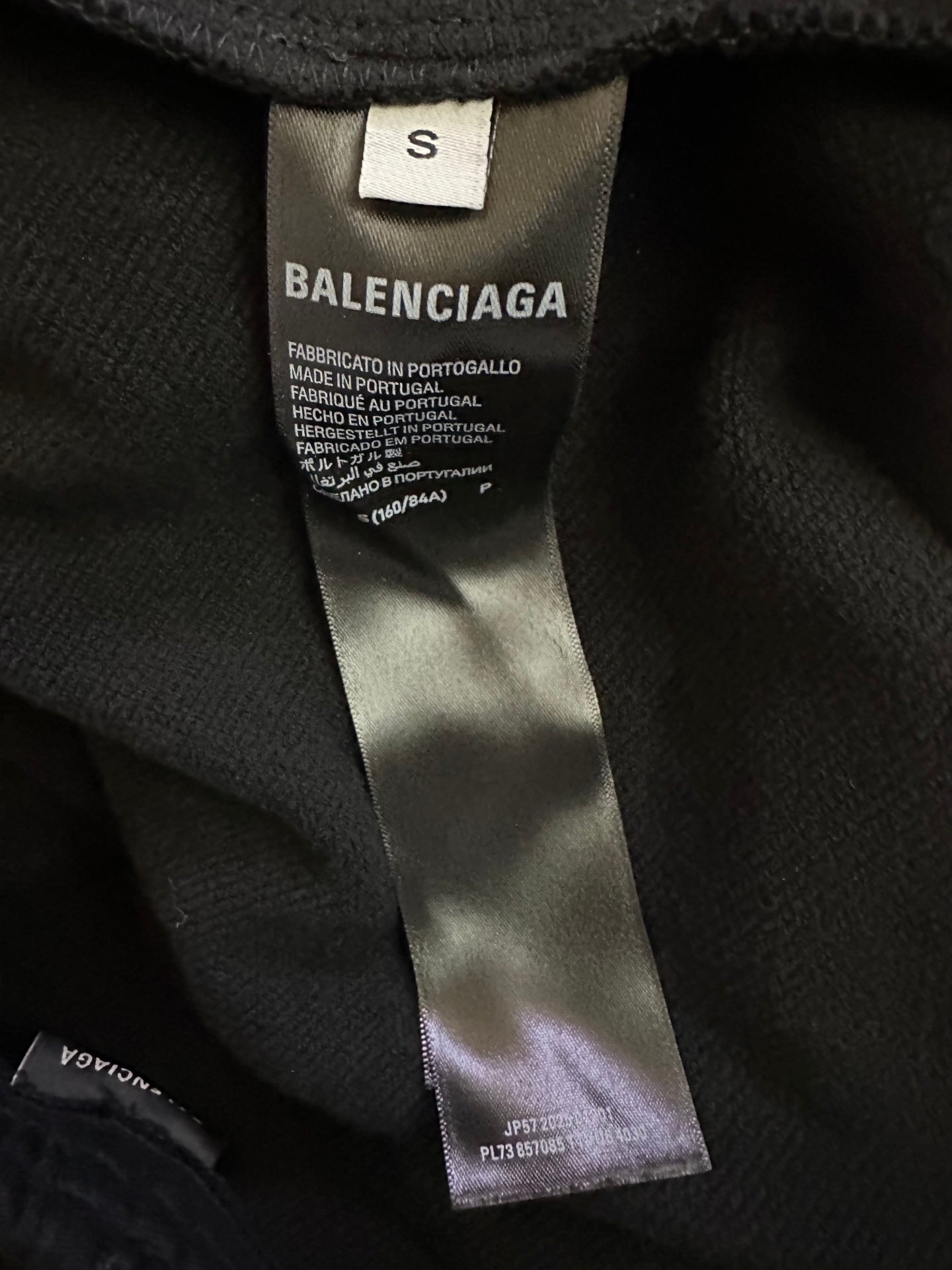 Black shorts interior with Balenciaga size tag and care label stitched on seam.