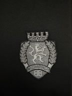 Black shorts crest logo patch with detailed silver-toned embroidery