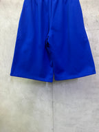 Royal blue shorts shown from the back with center back seam