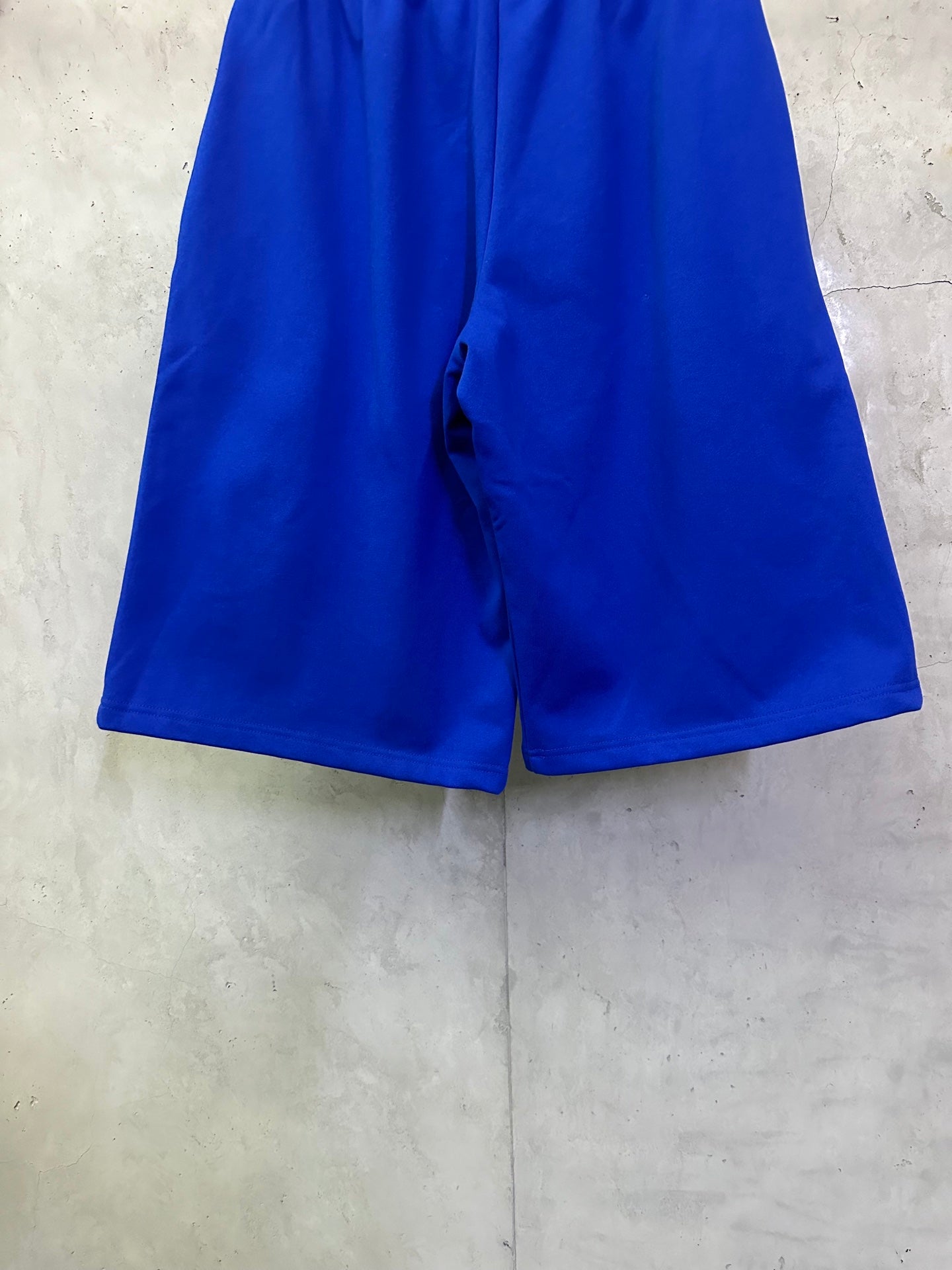 Royal blue shorts shown from the back with center back seam