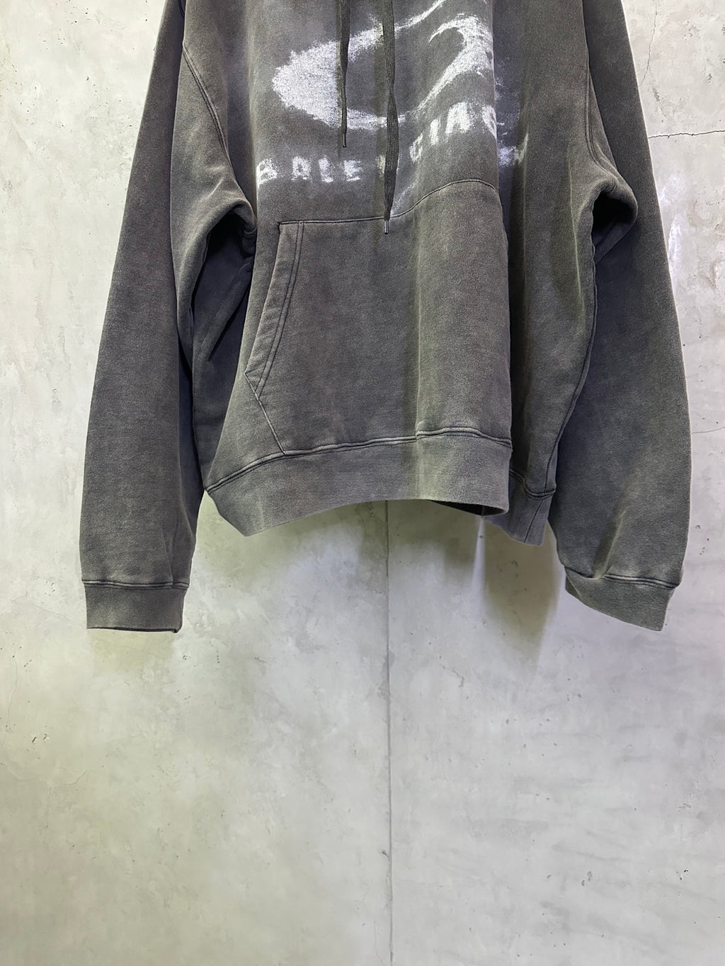 Balenciaga hooded sweatshirt front view, dark gray with distressed logo graphic