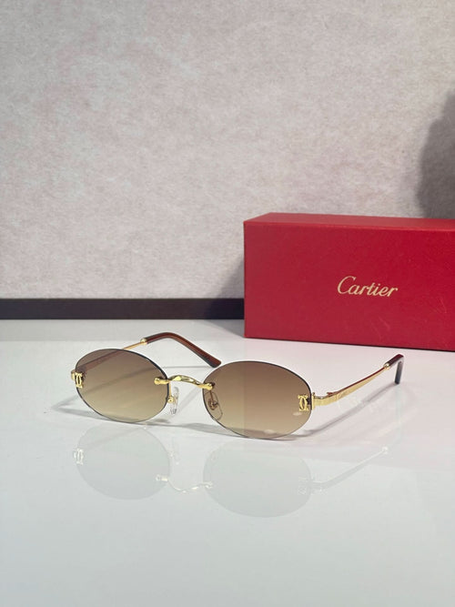 Sunglasses with round amber lenses and gold-tone frame with thin metal temples