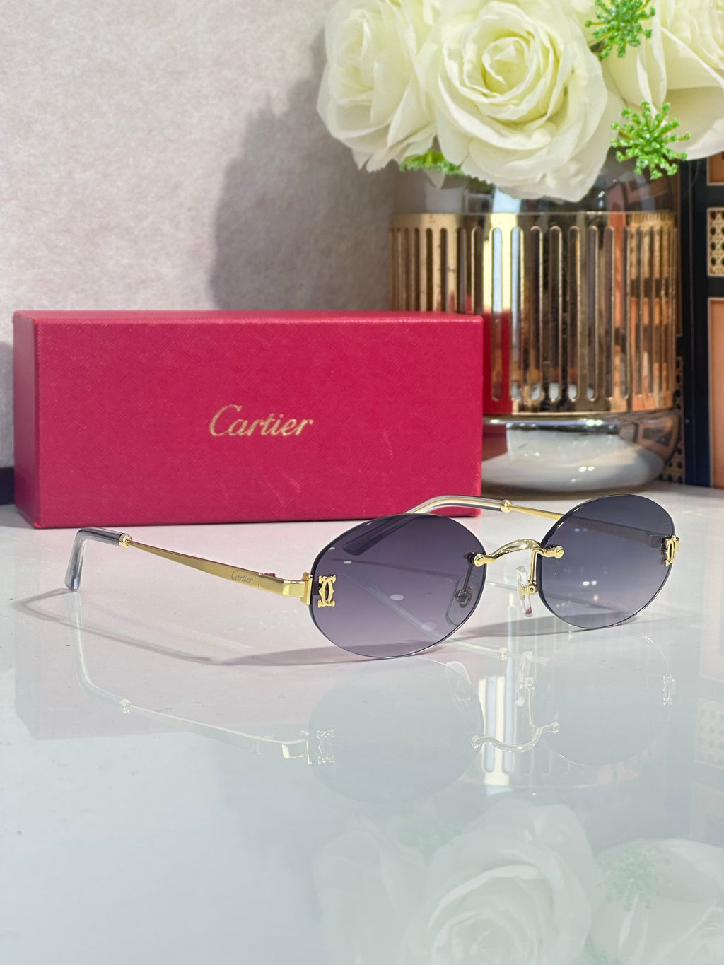 Round sunglasses with purple-tinted lenses and gold-tone metal frame