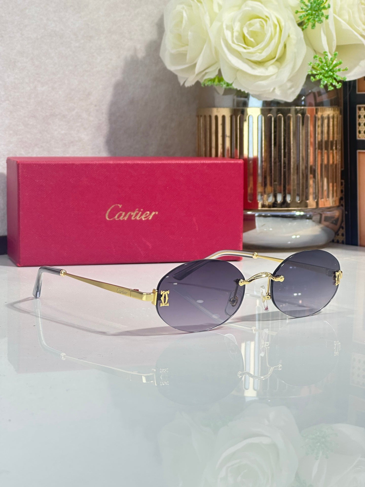 Round sunglasses with purple-tinted lenses and gold-tone metal frame