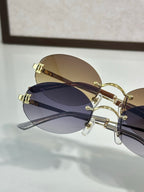Close-up of round sunglasses with tinted lenses and gold-tone metal frame