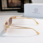 White square sunglasses shown from the side, with brown-tinted lenses and gold arms