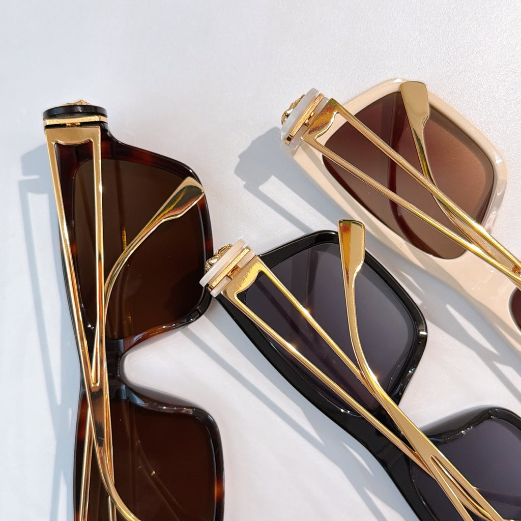 Assorted square sunglasses with gold-tone frames and brown and dark tinted lenses