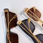 Assorted square sunglasses with gold-tone frames and brown and dark tinted lenses