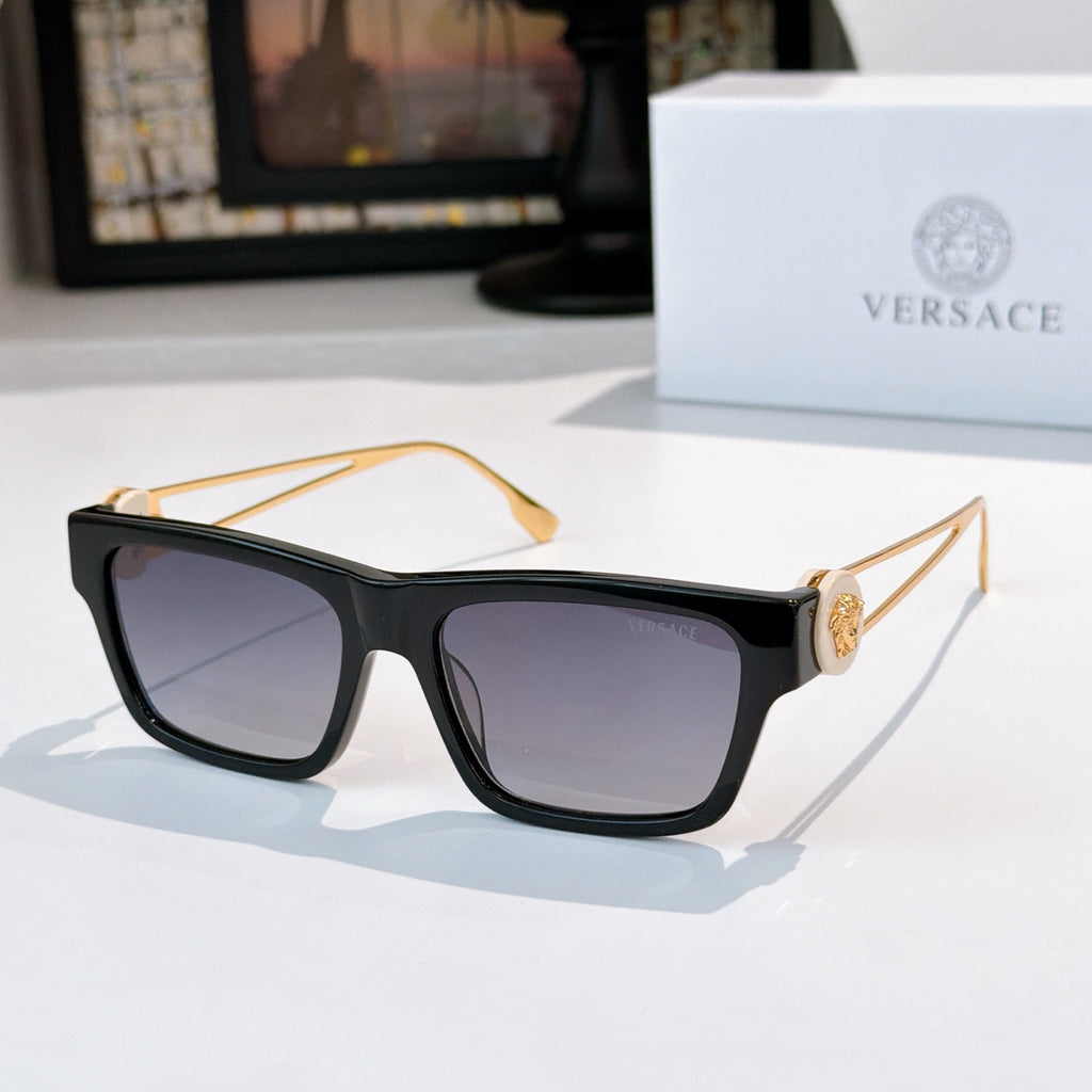 Black square sunglasses with dark lenses and gold-tone arms with emblem detail