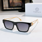 Black square sunglasses with dark lenses and gold-tone arms with emblem detail