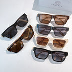 Assorted square sunglasses with dark, brown, and white frames and tinted lenses
