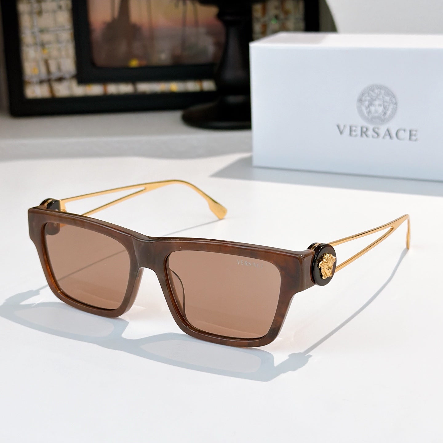 Tortoiseshell brown square sunglasses with tinted lenses and gold-tone arms