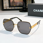 Sunglasses with dark gray lenses, gold-tone square frames, black temples and gold logo bar.