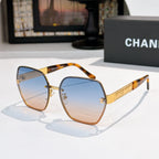 Sunglasses with blue gradient lenses, gold-tone square frames, amber tortoise temple tips.