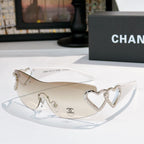 Silver heart-accent sunglasses with light frames and clear lenses