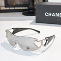 Silver heart-accent sunglasses with dark frames and tinted lenses