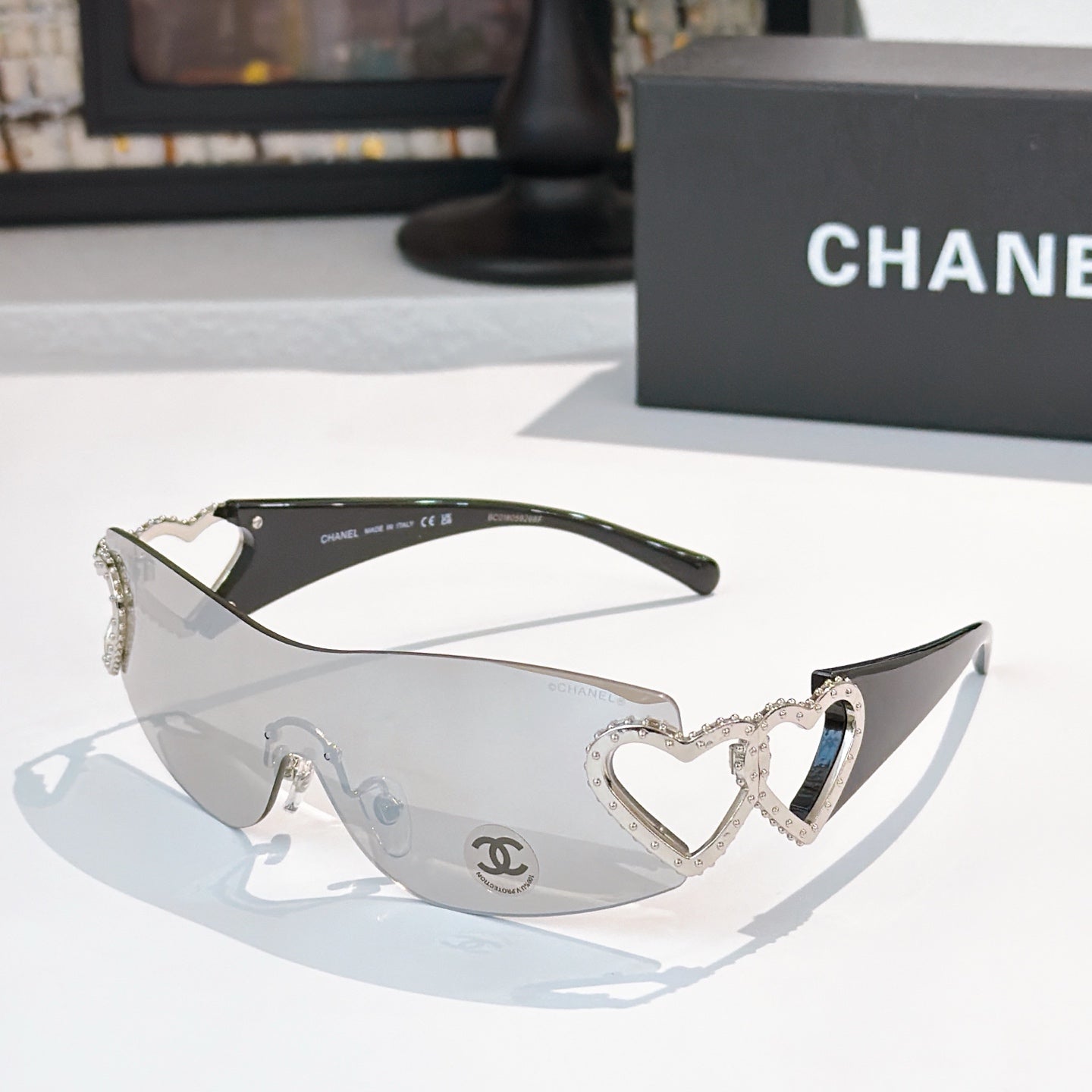 Silver heart-accent sunglasses with dark frames and tinted lenses