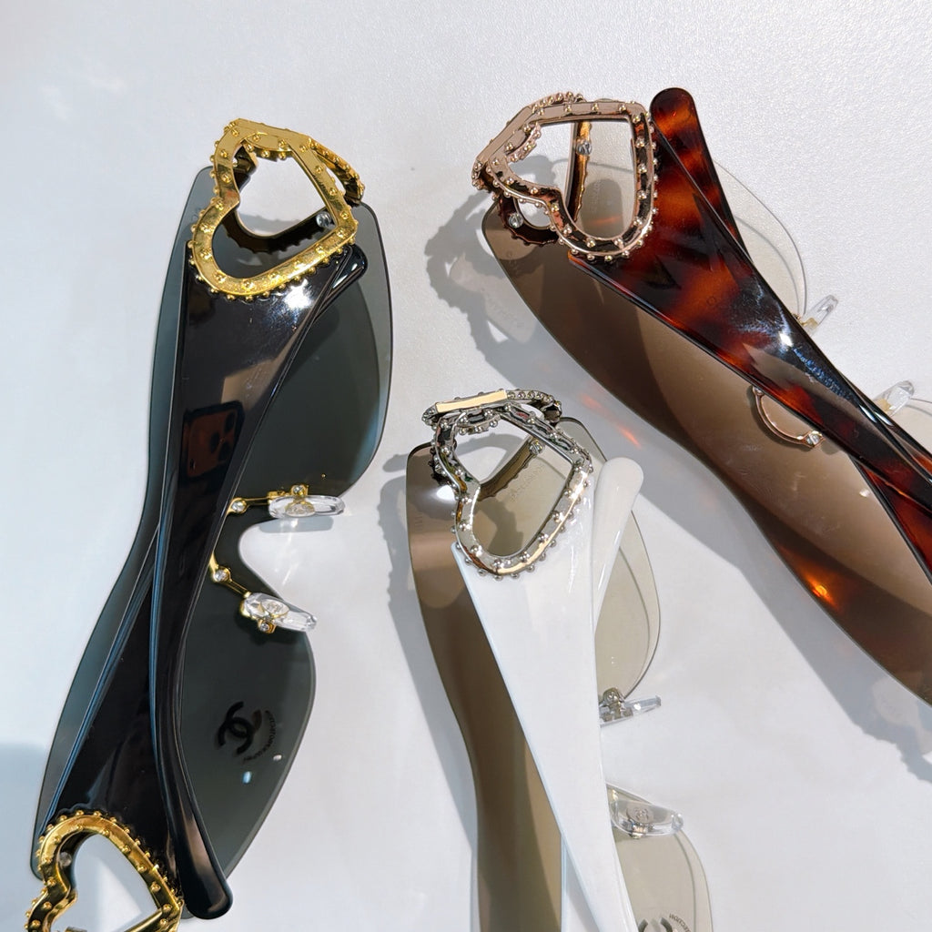 Assorted heart-accent sunglasses, including gold and tortoiseshell framed styles