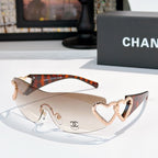 Tortoiseshell sunglasses with rose-gold heart detail and light tinted lenses