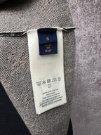 Inside neck label and care tag on knit sweater, with made in Italy text