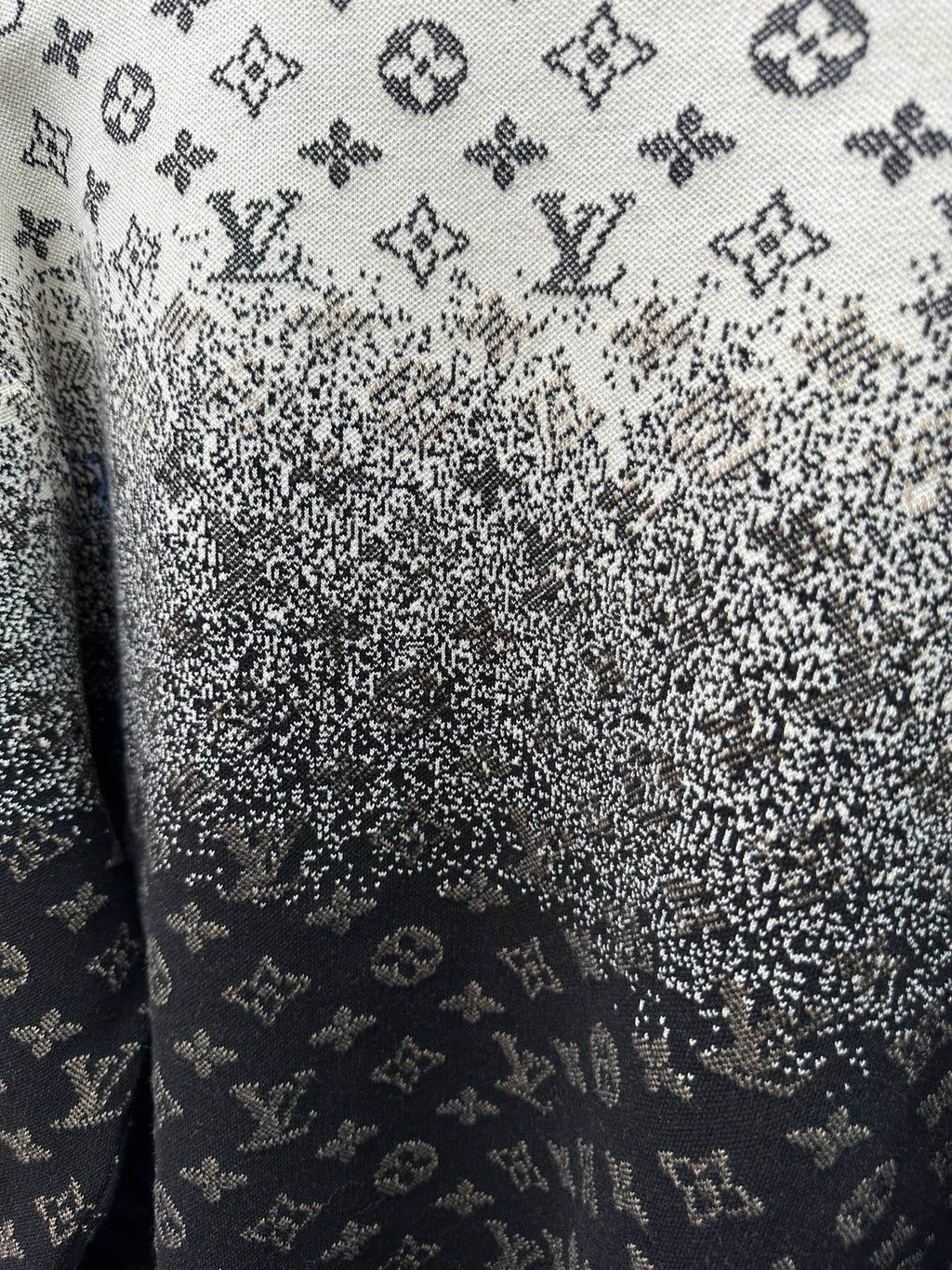 Close-up knit fabric with LV monogram pattern, dark navy and light gray speckles