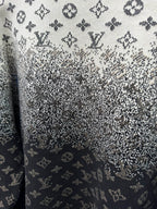 Close-up knit fabric with LV monogram pattern, dark navy and light gray speckles