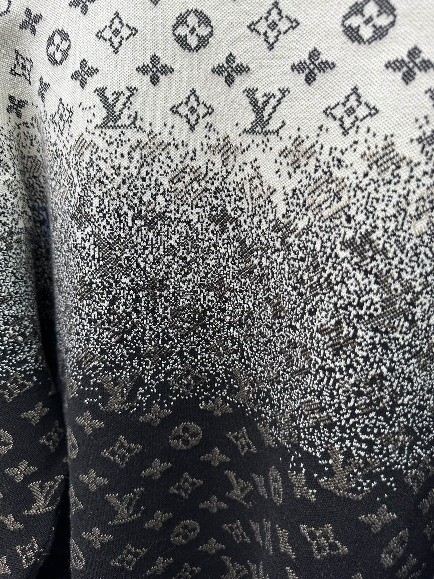 Close-up knit fabric with LV monogram pattern, dark navy and light gray speckles