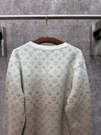 Back view light beige long-sleeve sweatshirt with allover monogram print