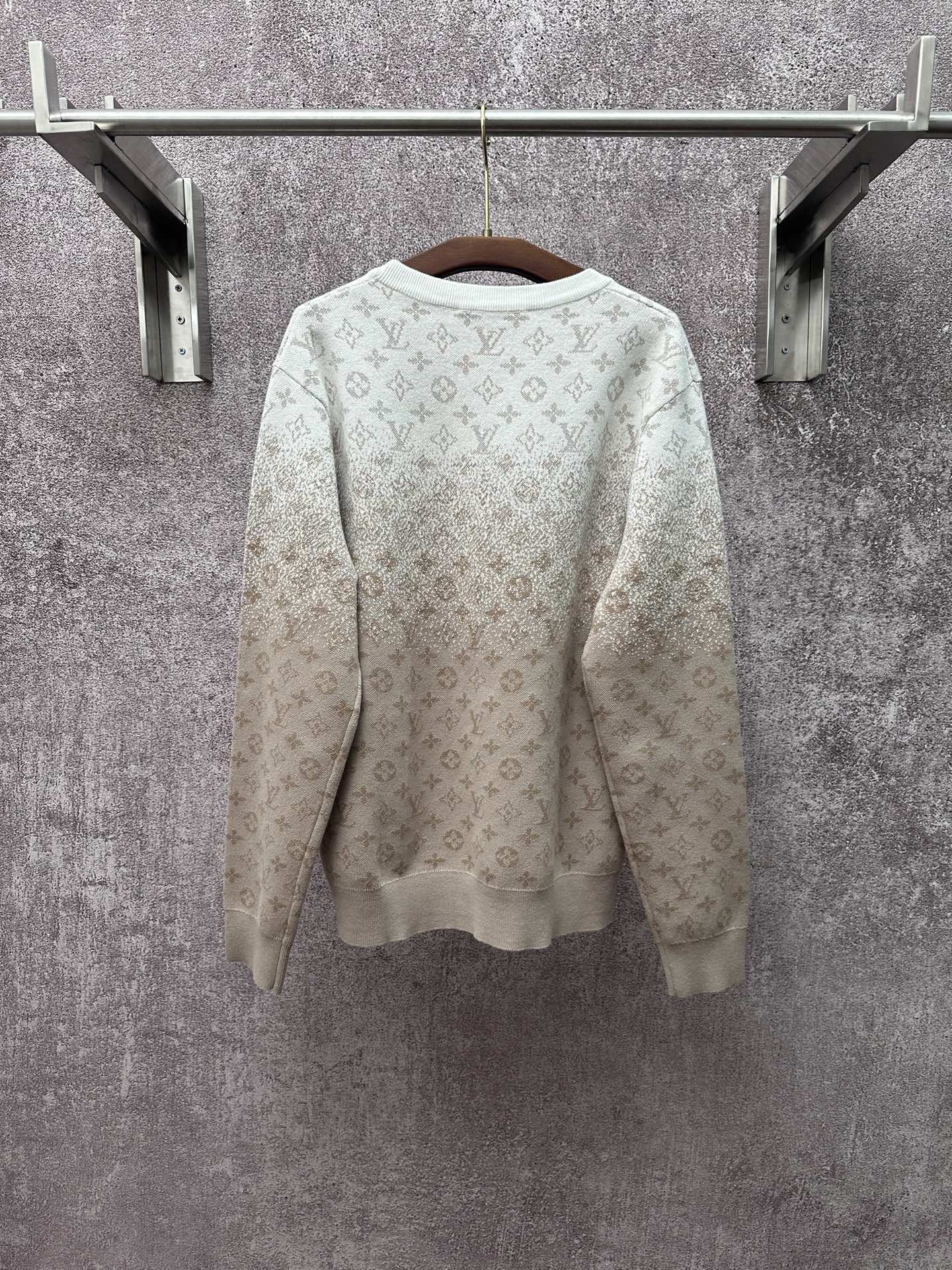 Back view light beige long-sleeve sweatshirt with allover monogram pattern