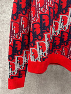 Dior monogram knit sweater lower torso, red ribbed hem and navy and white motifs