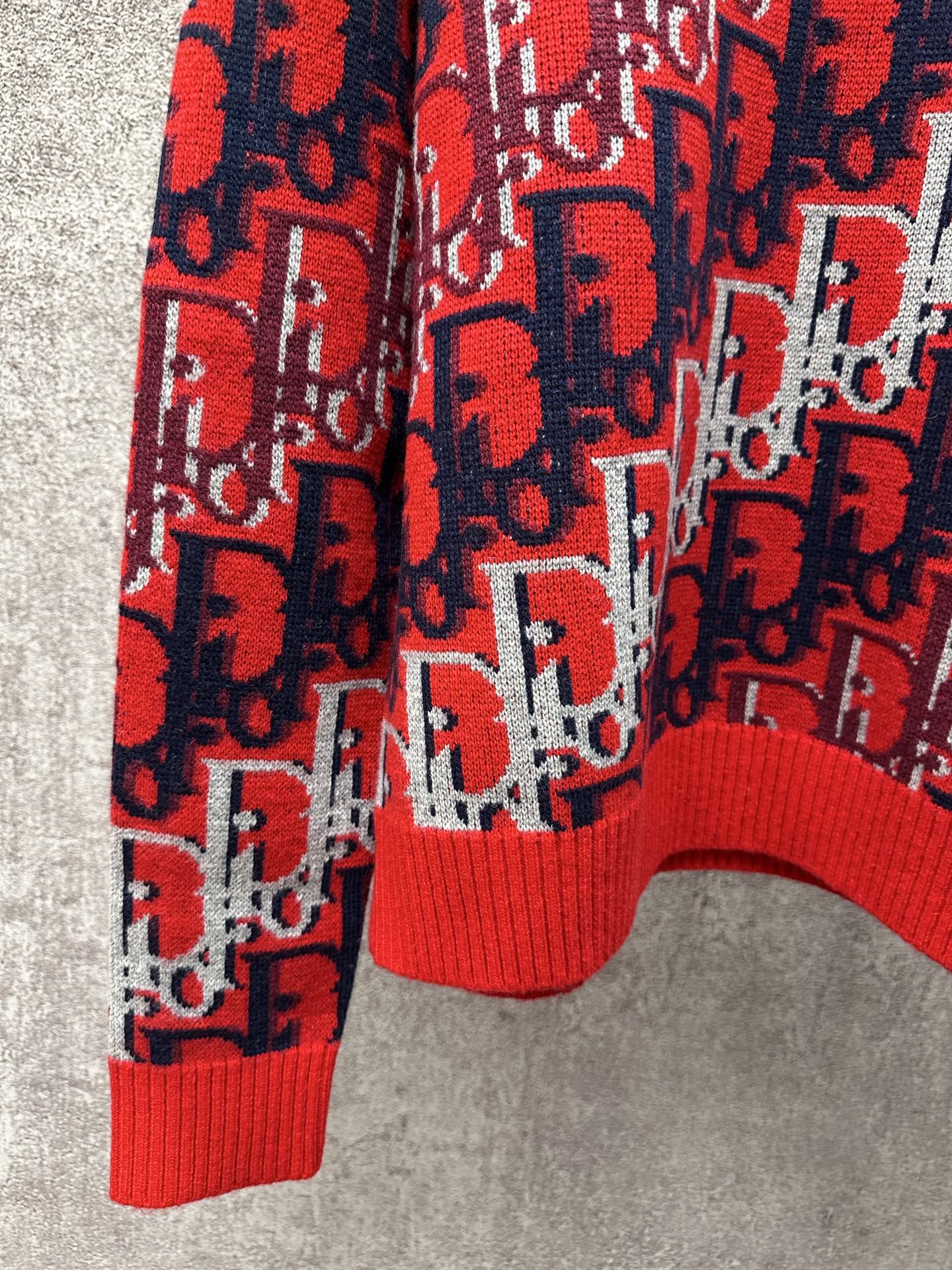 Dior monogram knit sweater lower torso, red ribbed hem and navy and white motifs
