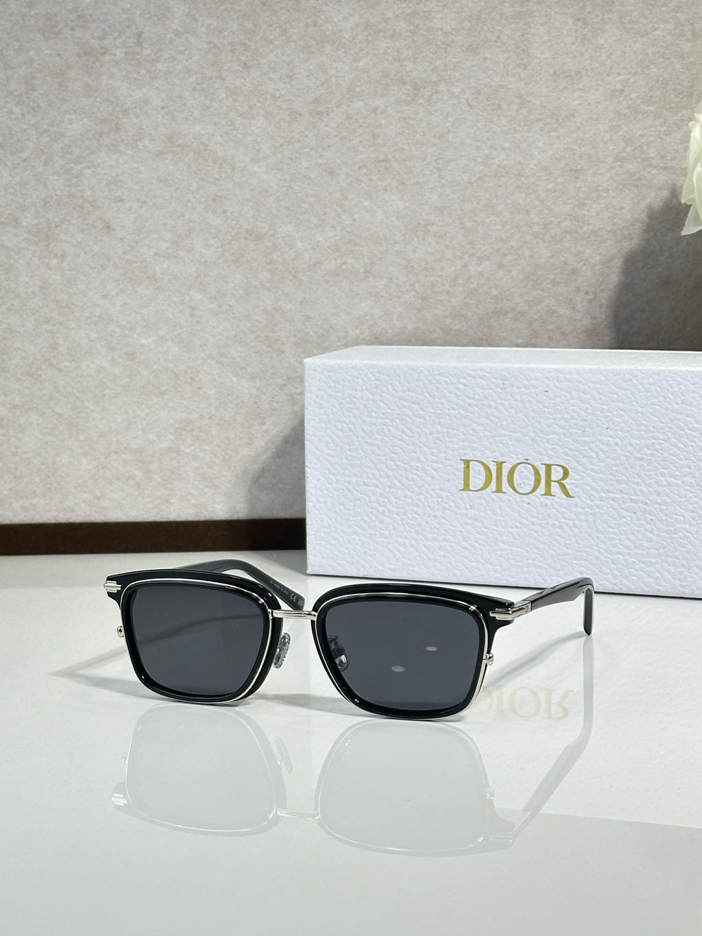 Black sunglasses with dark lenses and silver metal frame and temples