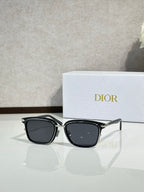 Black sunglasses with dark lenses and silver metal frame and temples