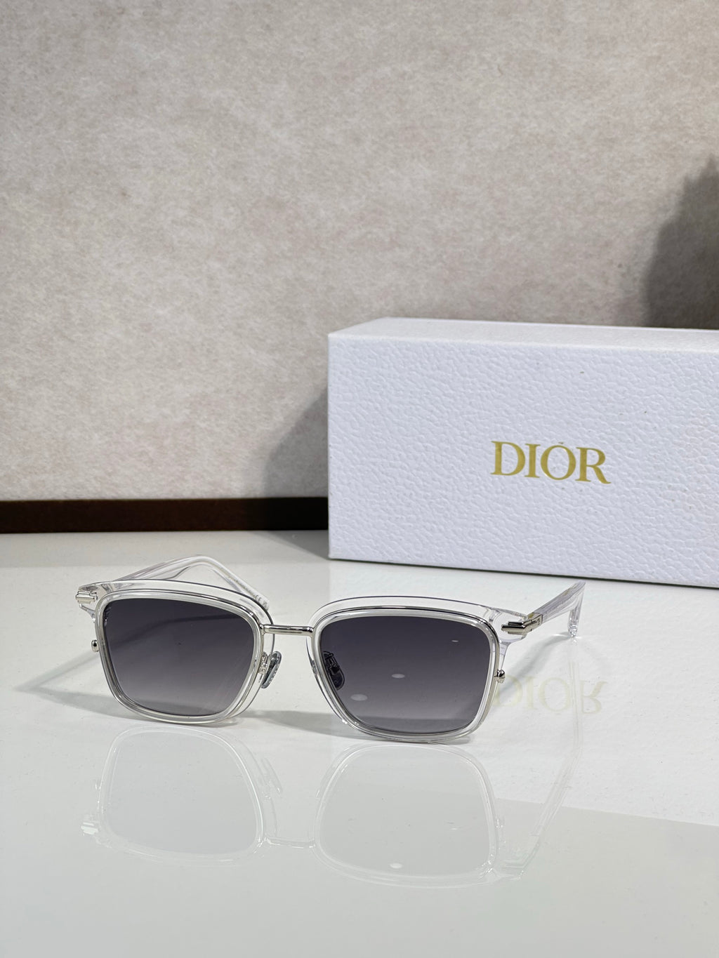 Silver-tone sunglasses with dark lenses and curved metal frame