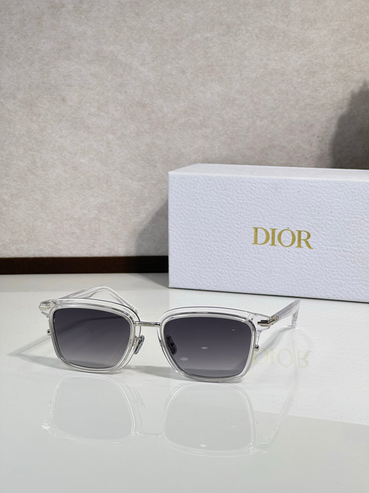 Silver-tone sunglasses with dark lenses and curved metal frame
