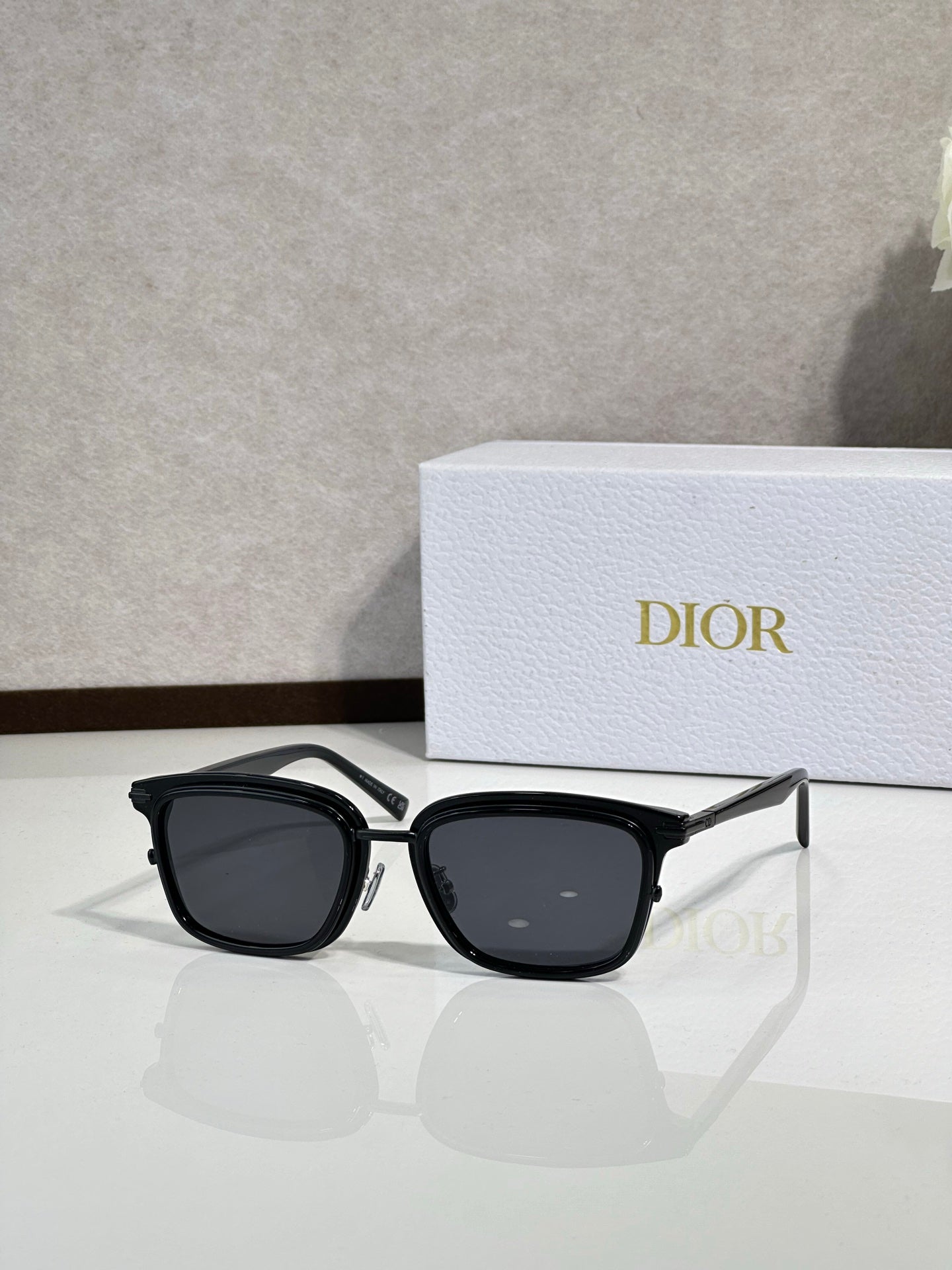 Black cat-eye sunglasses with dark lenses and silver-tone temples