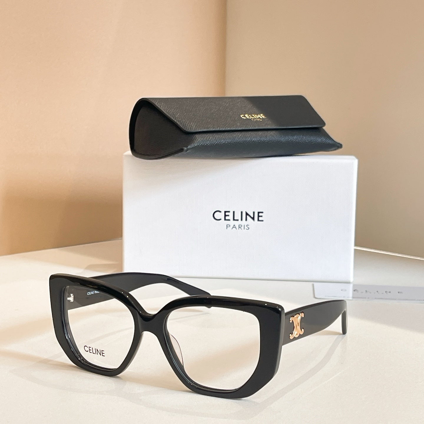 Celine glasses with black square frames and clear lenses.