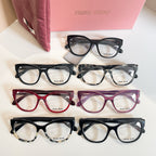 Set of MiuMiu eyeglasses with black, burgundy, and purple frames, clear lenses, logo temples
