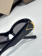 Bvlgari sunglasses close-up, black temple with gold logo and gold-trim hinge