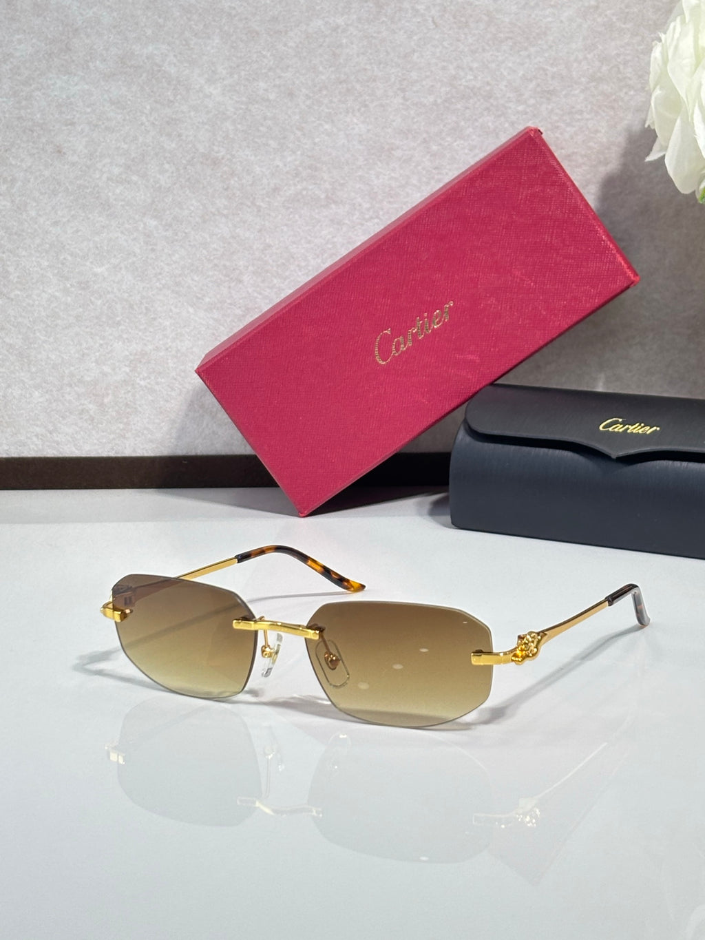 Gold-tone sunglasses with amber lenses and decorative metal temple accents