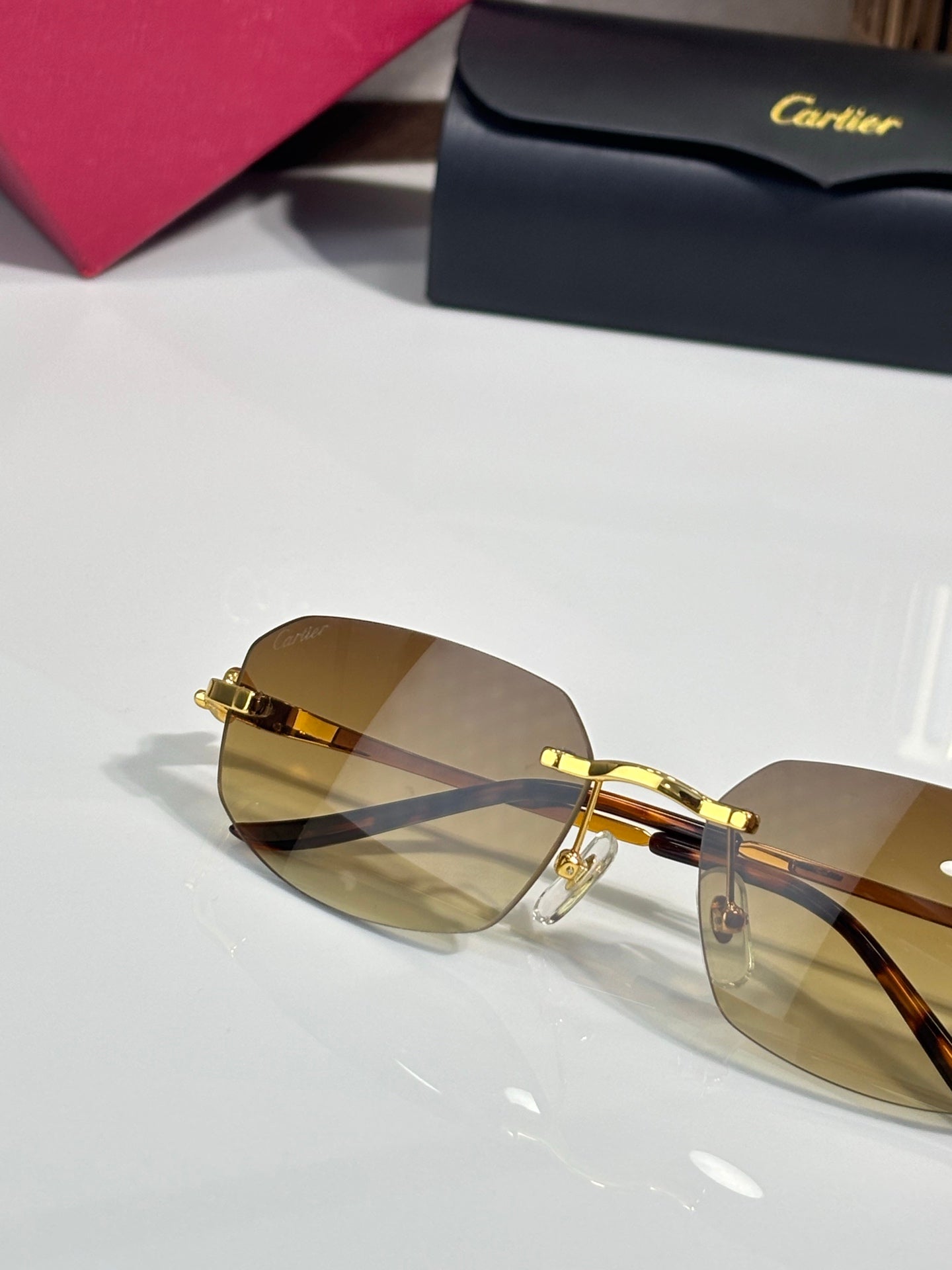 Gold-tone sunglasses with amber lenses and patterned tortoise-look temple tips