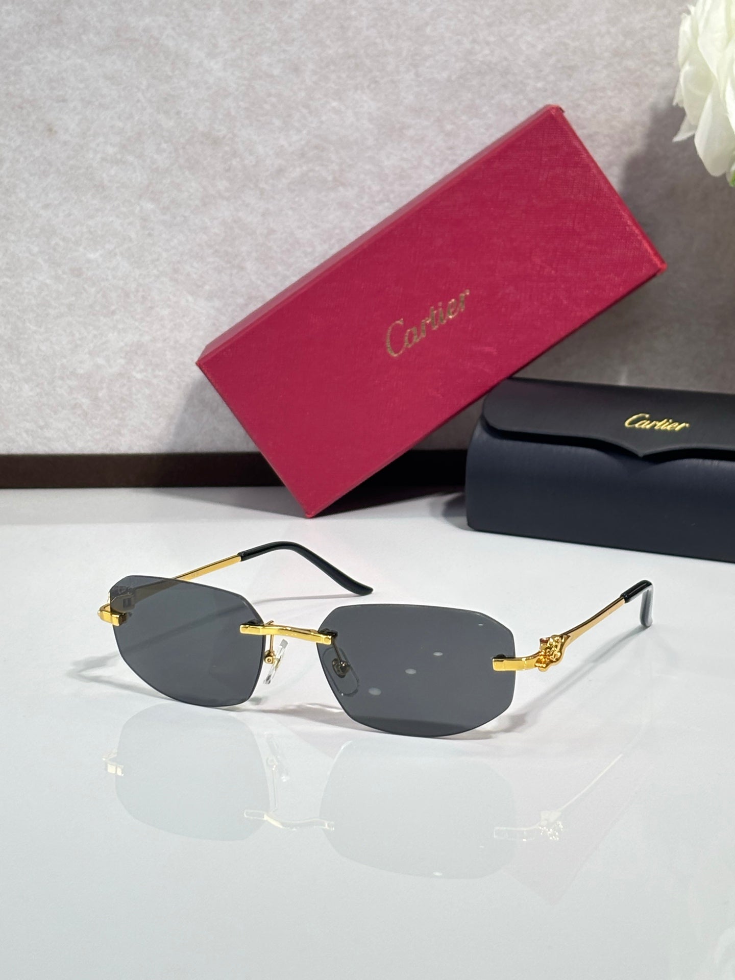 Gold-tone sunglasses with smoky gray lenses and black temple accents