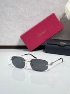 Gold-tone sunglasses with dark gray lenses and sculpted metal temple details